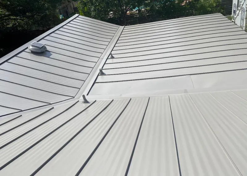 Solar attic fan installed on a metal roof for Roof Ventilation in Rice Lake